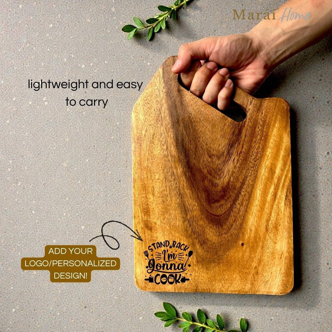 Marai Home acacia wood cutting board with handle, featuring a "Stand Back I'm Gonna Cook" graphic.