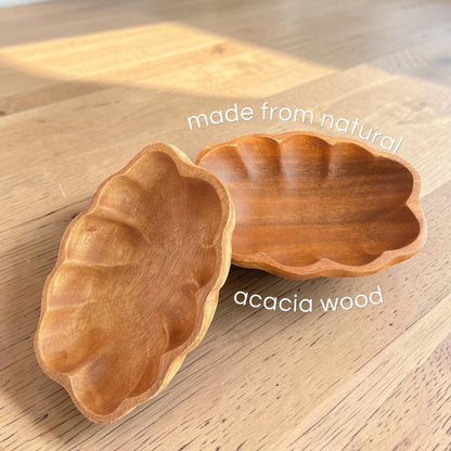 Marai Home handcrafted scallop-shaped serving bowls made from natural acacia wood with unique grain patterns.