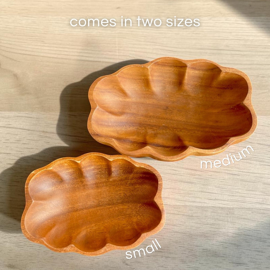 Marai Home small and medium scallop-shaped serving bowls crafted from natural acacia wood with unique grain patterns.
