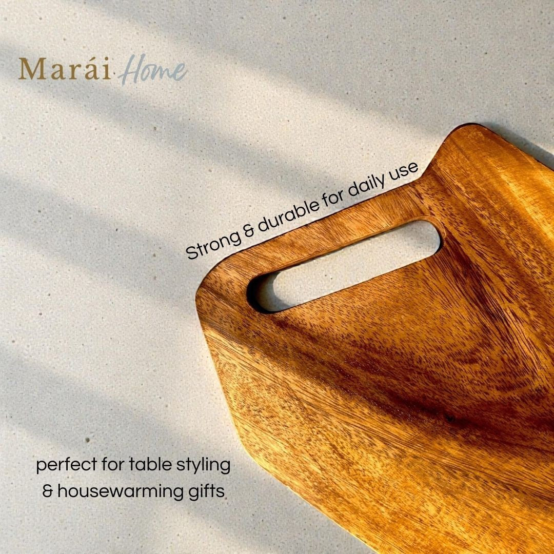 Marai Home acacia wood personal cutting and serving board with handle cutout. Natural wood grain.