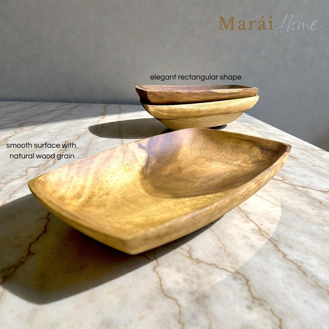 Marai Home rectangle serving dish made of solid acacia wood with a smooth natural grain finish on a marble surface.