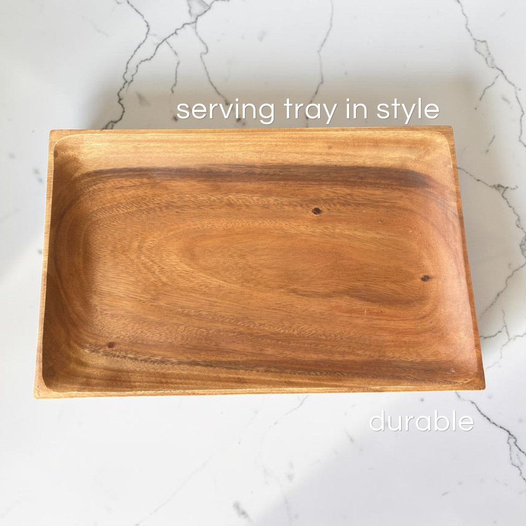 Marai Home rectangular acacia wood serving tray with natural grain finish on a white marble surface