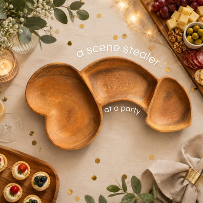 Marai Home Party Starter naughty-shaped acacia wood charcuterie board on a festive table with snacks.