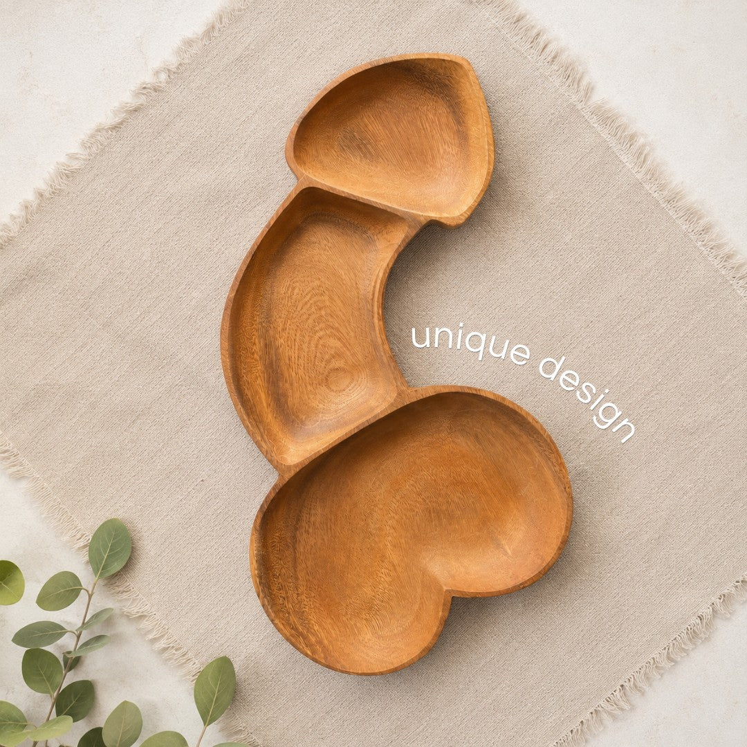 Marai Home naughty acacia wood charcuterie board with a unique phallic shape on a beige linen napkin