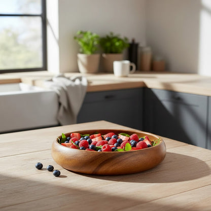Marai Home wooden calabash bowl filled with fresh strawberries and blueberries on a rustic kitchen table